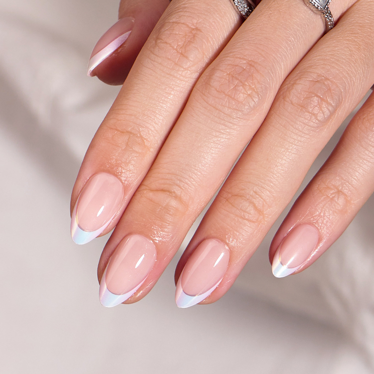 Hand model wearing natural pink press on nails with white nail tips Australia